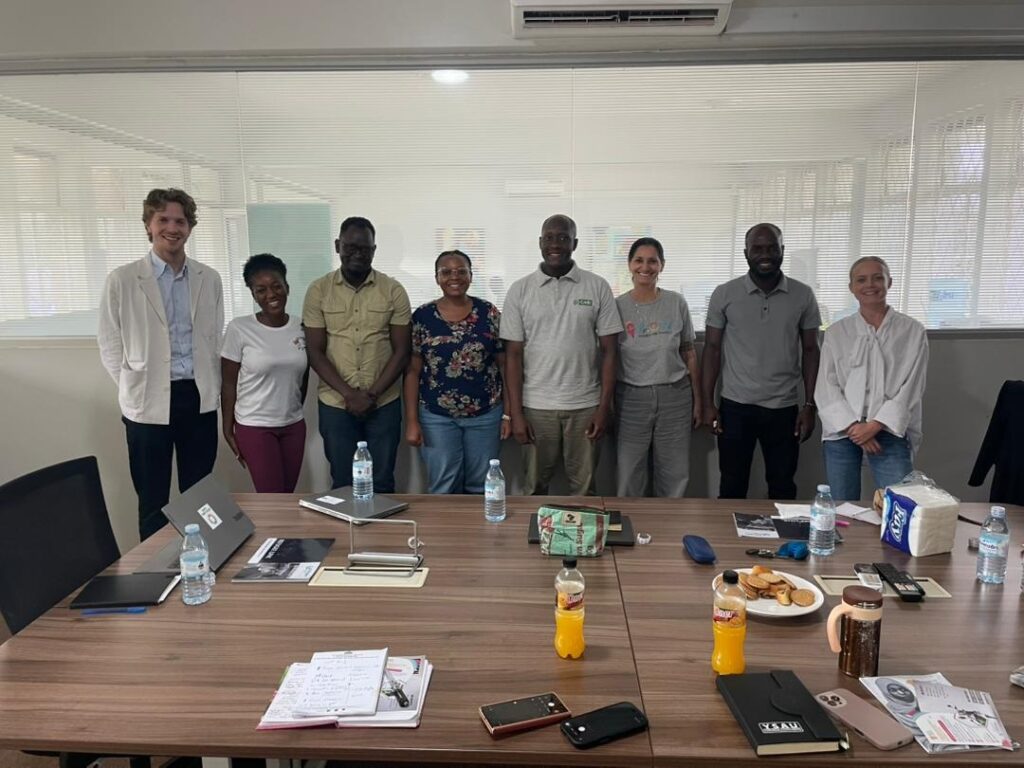 Group photo of RefugeeLINK, LM International, Women Rising for Africa, and GreenHub after a partnership meeting in Kampala.