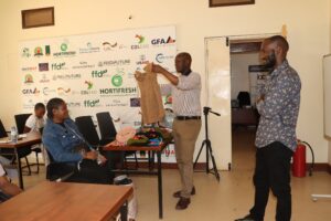 RefugeeLink's Kevin, displaying a refugee's knitted fabrics