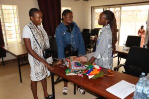 RefugeeLink's Corinne(right) and an attendee left, admiring knitted fabrics