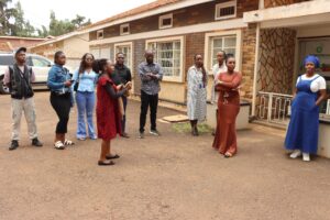 Flavia, of RefugeeLink(front left) leading a guided tour of the RefugeeLink premises