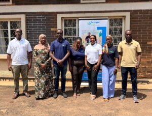 RefugeeLink's staff pose for a group picture at the FGD that was hosted at their premises